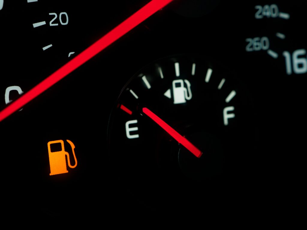Close-up of a car fuel gauge showing an empty tank
