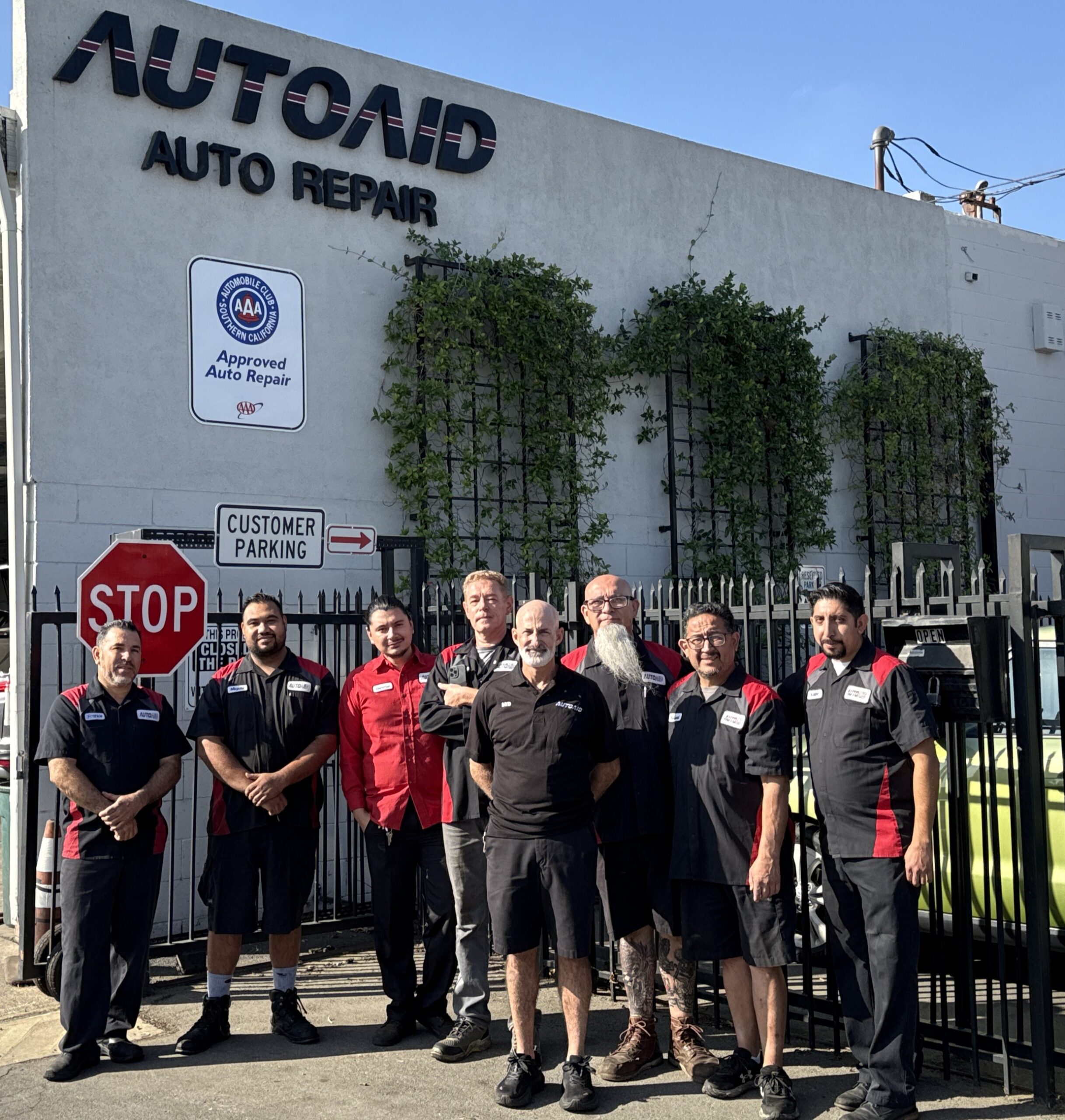 AutoAid team standing in front of their auto repair shop.