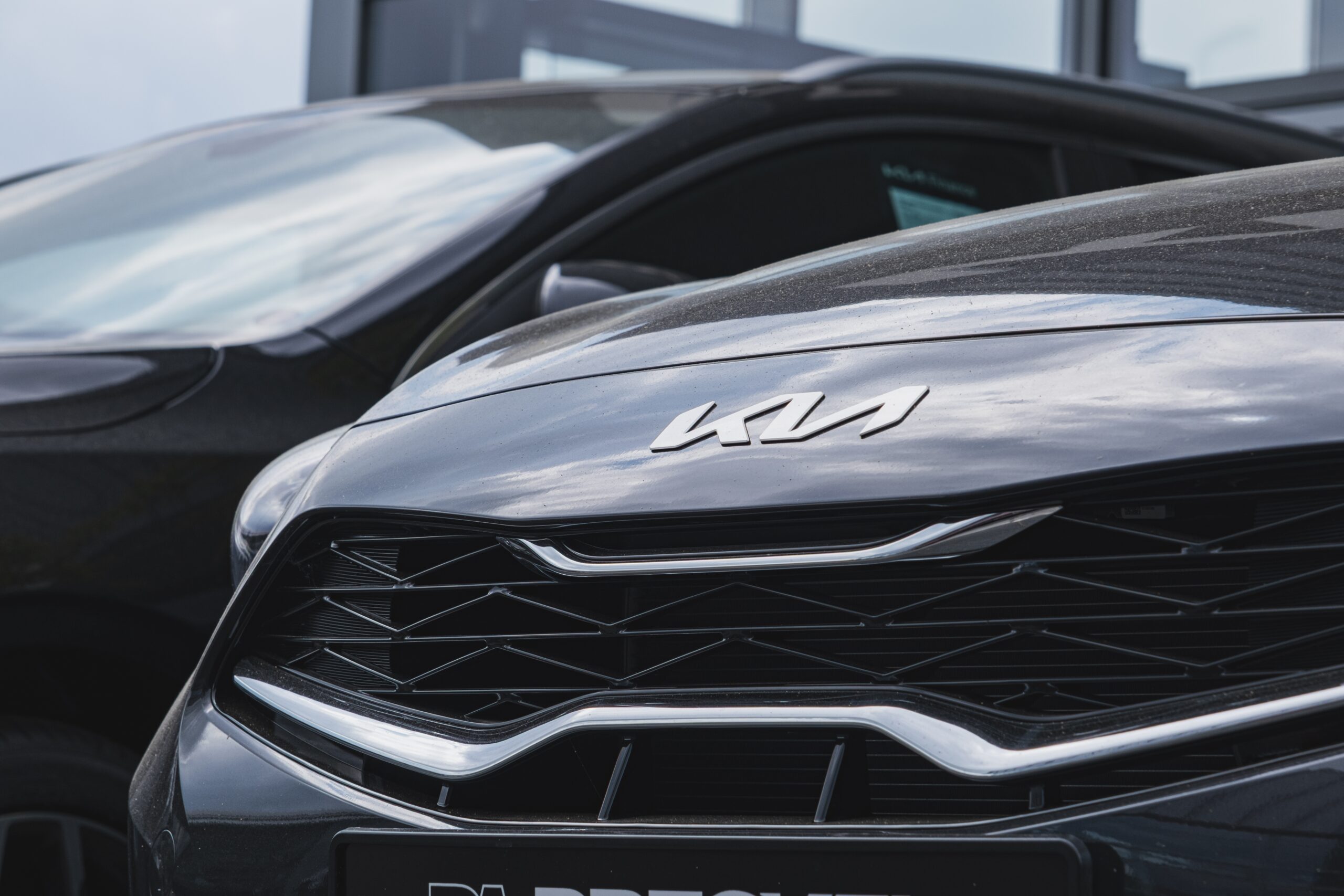 Close-up view of KIA badge on a car