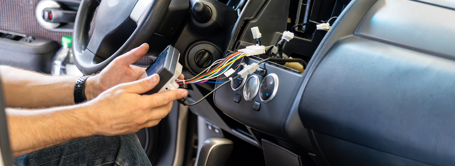 Auto mechanic repairing dashboard wiring