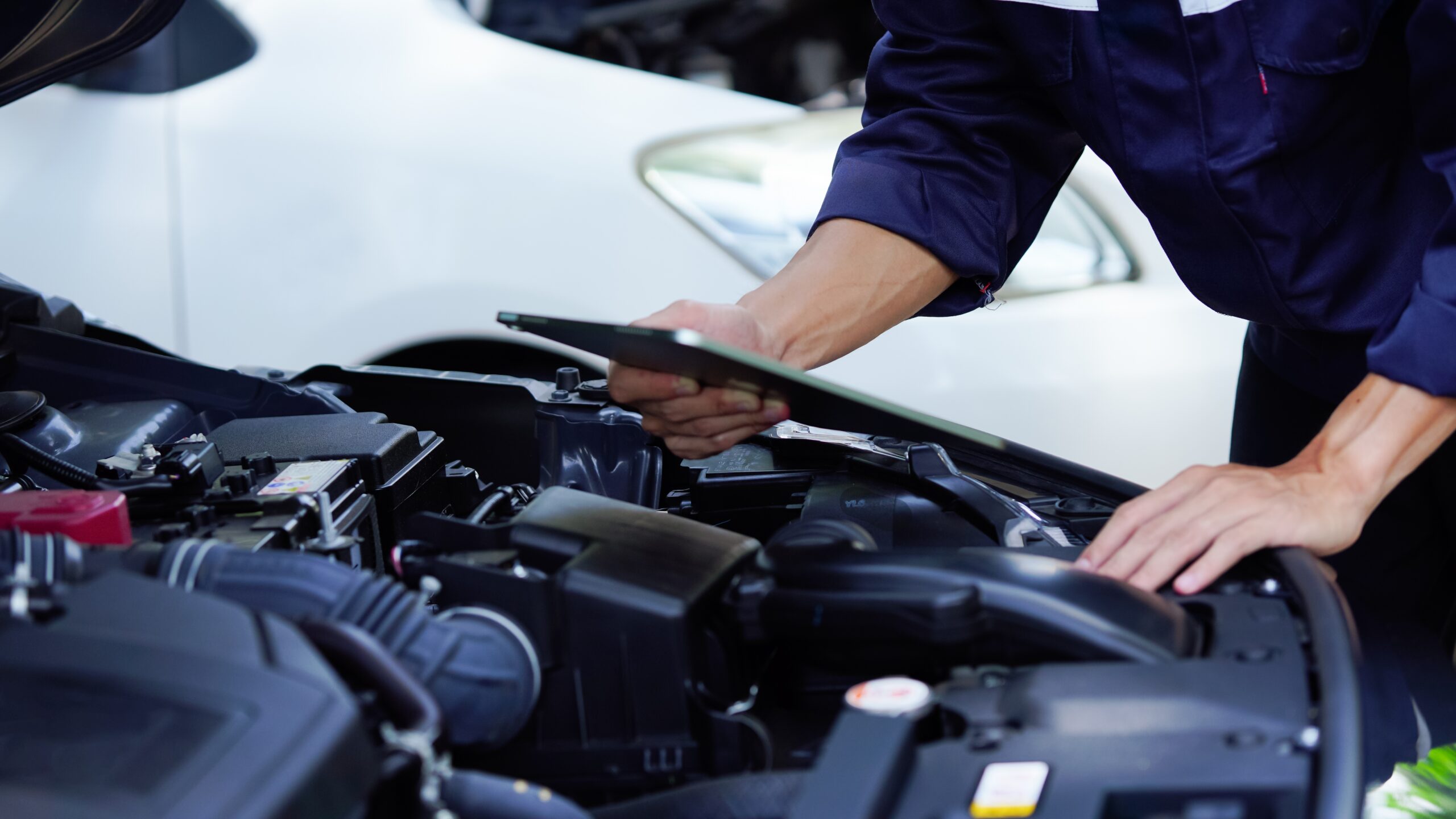 Auto mechanic checks vehicle