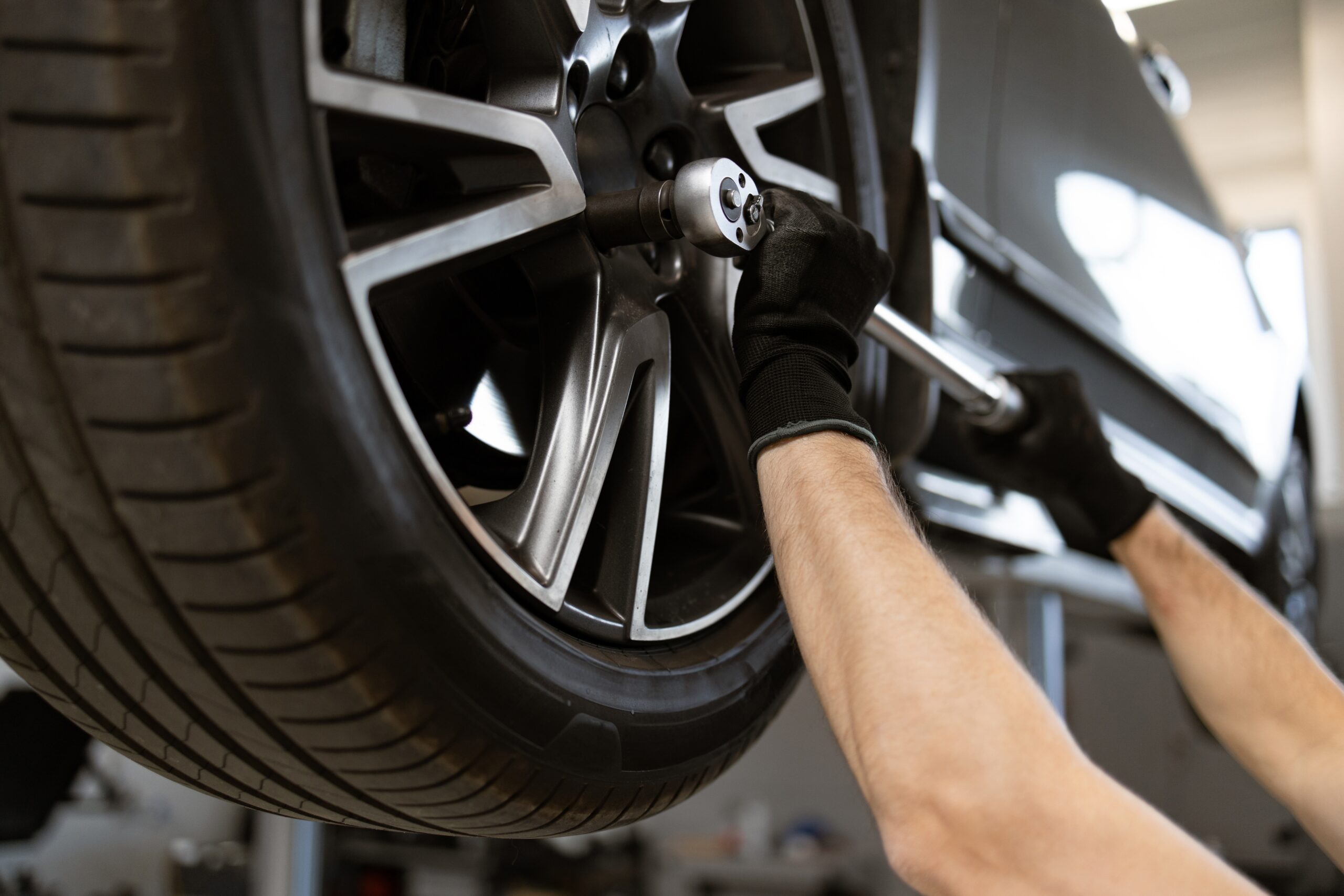 Auto mechanic installing new tire