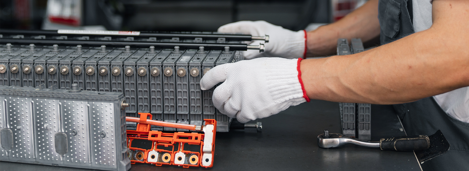 Auto mechanic repairs electric battery pack of hybrid car