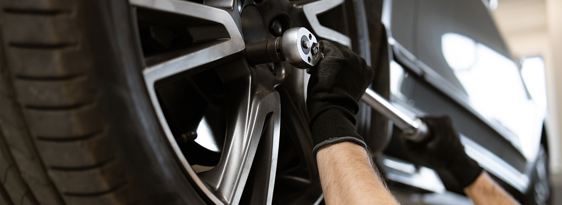 Auto mechanic installing new tire