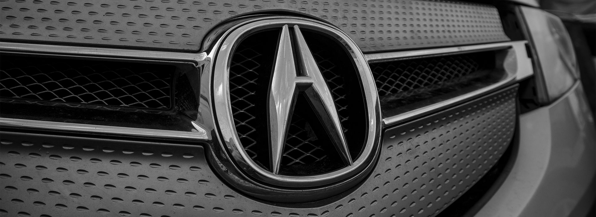 Acura logo on the front of the car