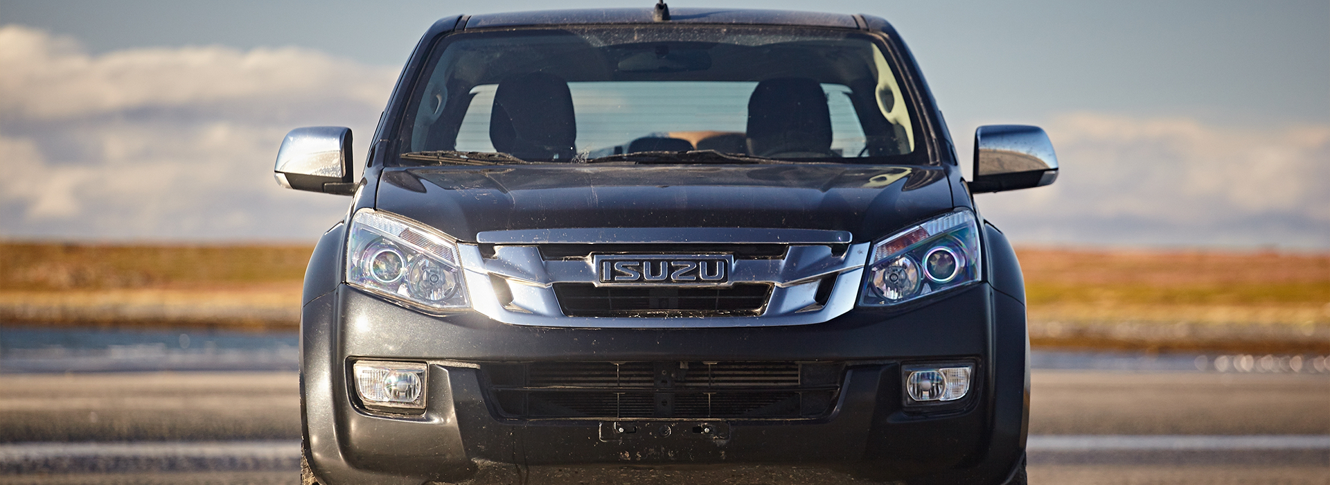 Isuzu logo on the front of an SUV