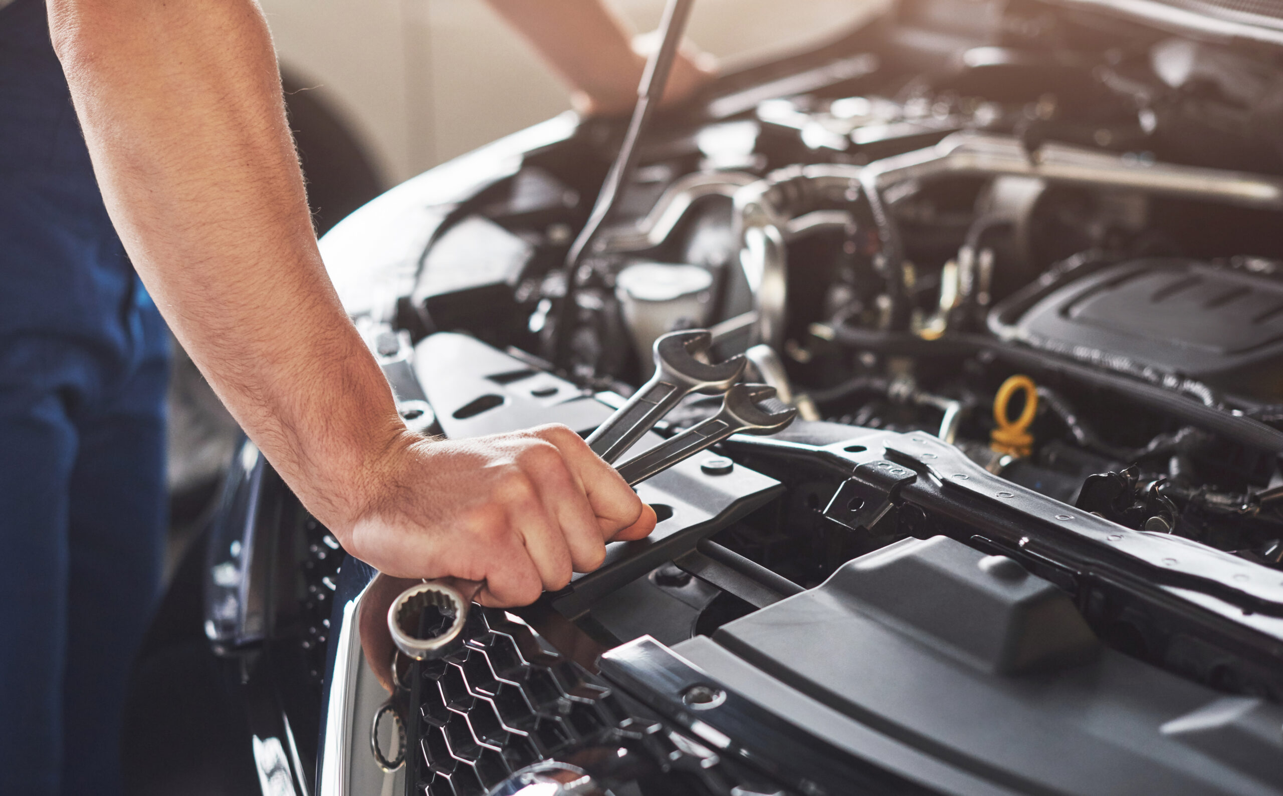 Car mechanic working on vehicle